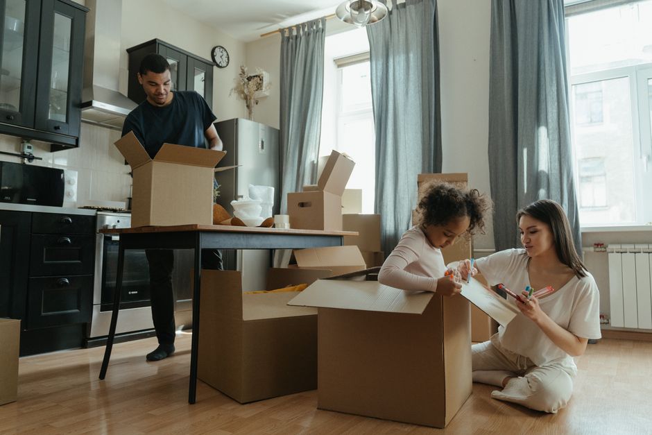 A family unpacks boxes in their new kitchen, enjoying the moving-in process.